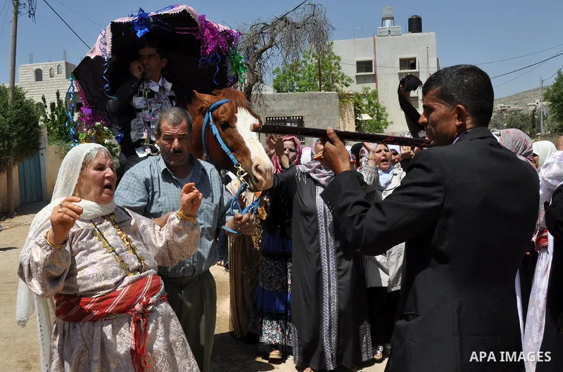 Relatives Palestinian groom Abbas Thawabteh, dancing during heritage wedding in the village of Azmut eastern city of Nablus in the West Bank,on 27 April 2012. Photo by Nedal Shtieh. Photo by Nedal Shtieh