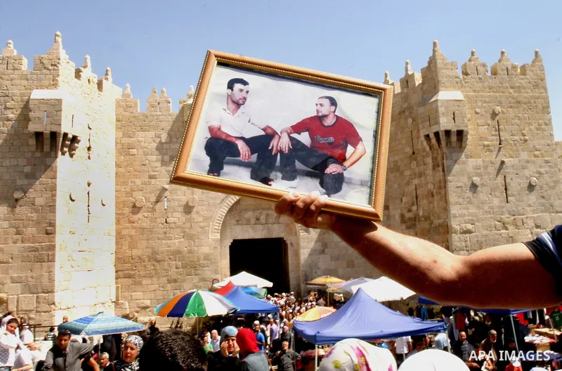 Palestinians hold portraits of relatives jailed in Israeli prisons as they protest to demand for their release, in the Al Aqsa Mosque compound in Jerusalem's Old City, on April 27, 2012. After decades of shying away from...