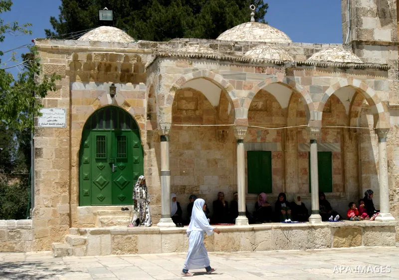 A Palestinian family walks past the Dome of the Rock Mosque in the Al Aqsa Mosque compound in Jerusalem's Old City, on April 27, 2012. After decades of shying away from an ancient pilgrimage route, Muslims are visiting J...