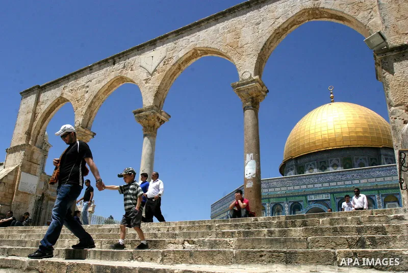 A Palestinian family walks past the Dome of the Rock Mosque in the Al Aqsa Mosque compound in Jerusalem's Old City, on April 27, 2012. After decades of shying away from an ancient pilgrimage route, Muslims are visiting J...
