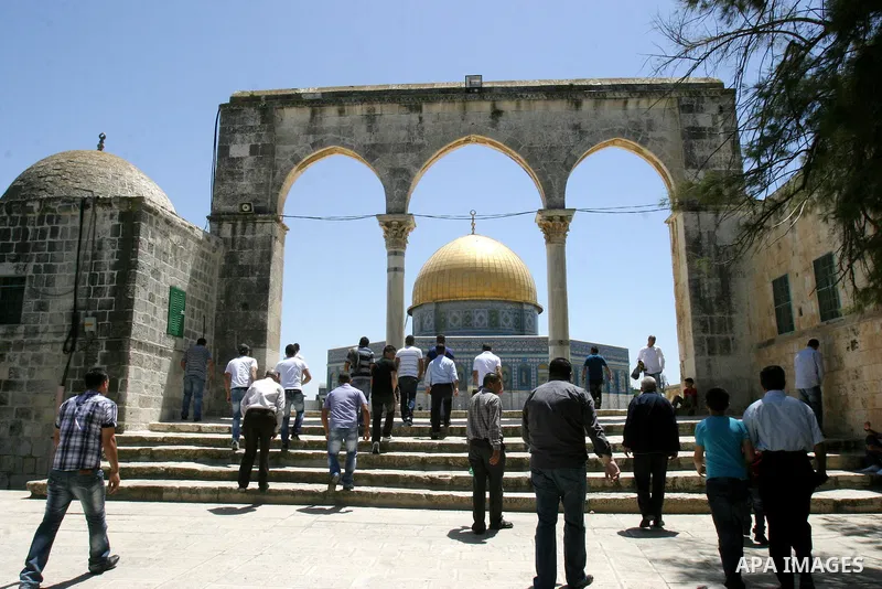 Palestinians walk past the Dome of the Rock Mosque in the Al Aqsa Mosque compound in Jerusalem's Old City, on April 27, 2012. After decades of shying away from an ancient pilgrimage route, Muslims are visiting Jerusalem...