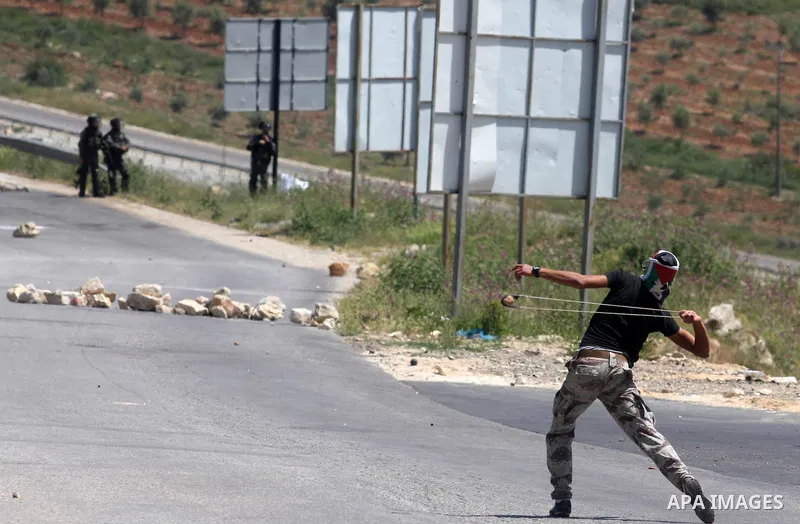 Palestinian youths and Israeli troops clash during a weekly demonstration against the expansion of the nearby Jewish settlement of Halamish in the West Bank village of Nabi Saleh near Ramallah, Friday, April 27, 2012. Ph...