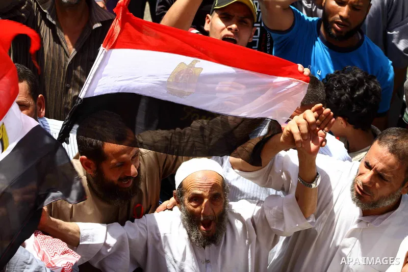 People attend Friday prayers in Tahrir Square in Cairo April 27, 2012. Tens of thousands of Egyptians demanded on Friday that their military rulers stick to a pledge to hand over power by mid-year after a row over who ca...