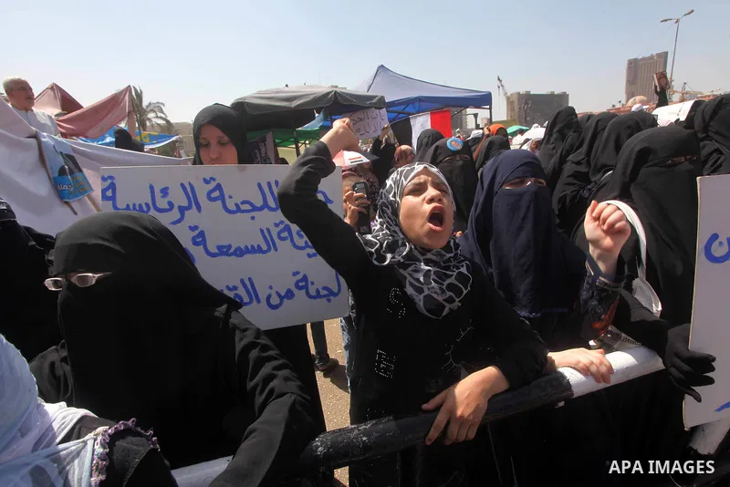 People attend Friday prayers in Tahrir Square in Cairo April 27, 2012. Tens of thousands of Egyptians demanded on Friday that their military rulers stick to a pledge to hand over power by mid-year after a row over who ca...