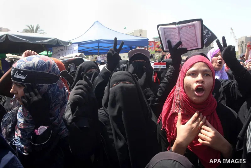 People attend Friday prayers in Tahrir Square in Cairo April 27, 2012. Tens of thousands of Egyptians demanded on Friday that their military rulers stick to a pledge to hand over power by mid-year after a row over who ca...