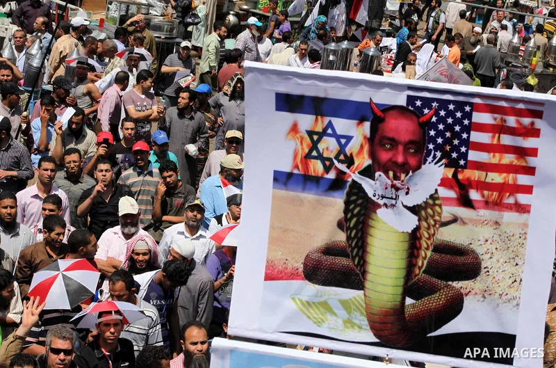 People attend Friday prayers in Tahrir Square in Cairo April 27, 2012. Tens of thousands of Egyptians demanded on Friday that their military rulers stick to a pledge to hand over power by mid-year after a row over who ca...