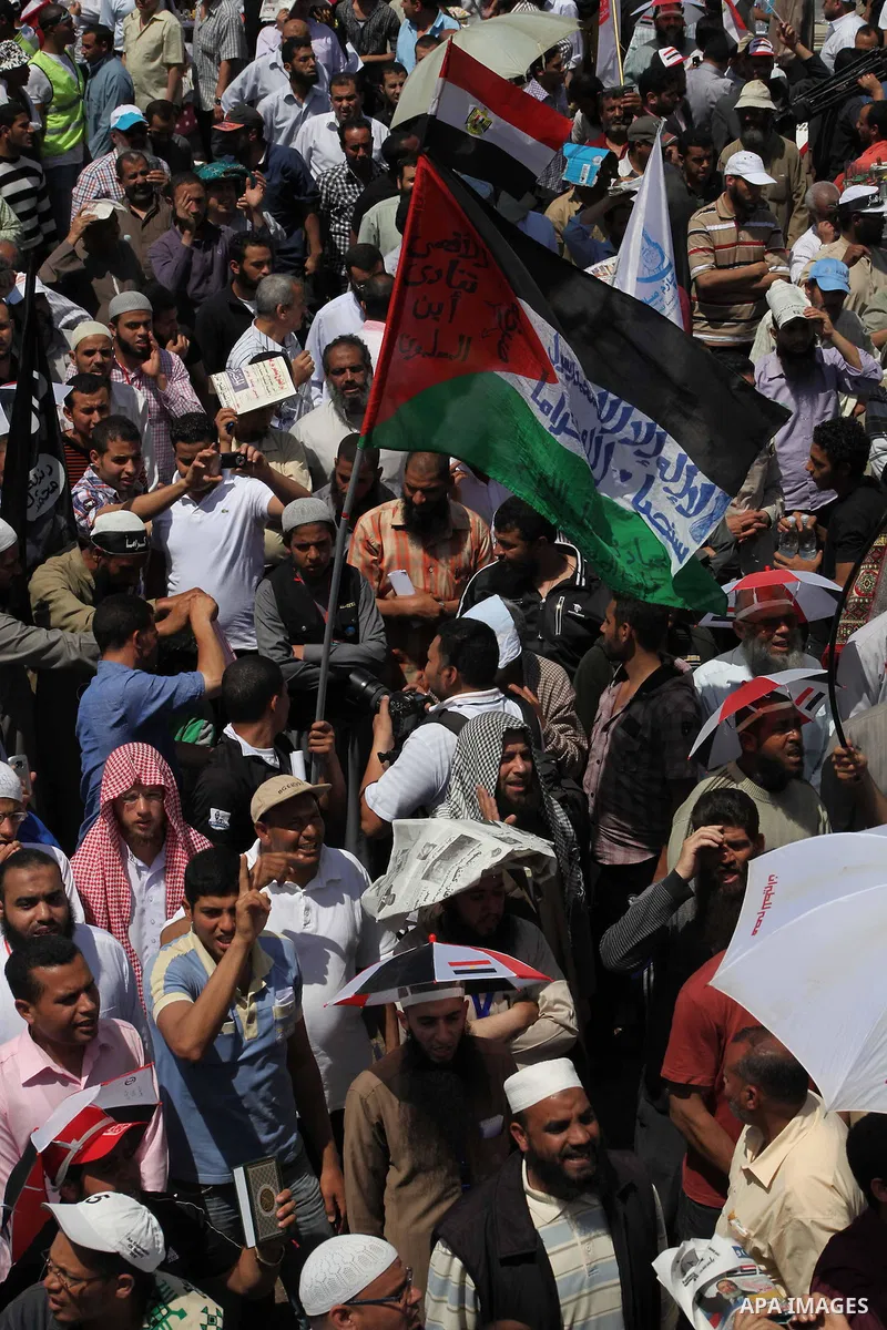 People attend Friday prayers in Tahrir Square in Cairo April 27, 2012. Tens of thousands of Egyptians demanded on Friday that their military rulers stick to a pledge to hand over power by mid-year after a row over who ca...