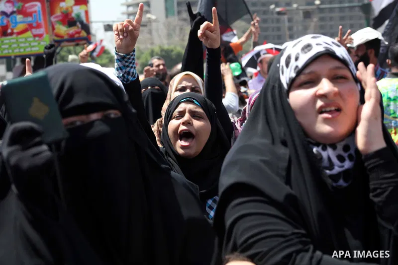 People attend Friday prayers in Tahrir Square in Cairo April 27, 2012. Tens of thousands of Egyptians demanded on Friday that their military rulers stick to a pledge to hand over power by mid-year after a row over who ca...