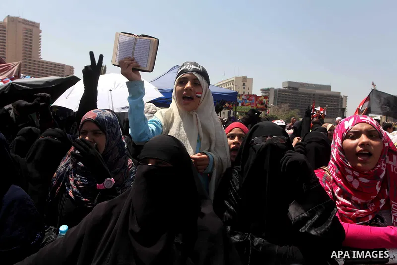 People attend Friday prayers in Tahrir Square in Cairo April 27, 2012. Tens of thousands of Egyptians demanded on Friday that their military rulers stick to a pledge to hand over power by mid-year after a row over who ca...