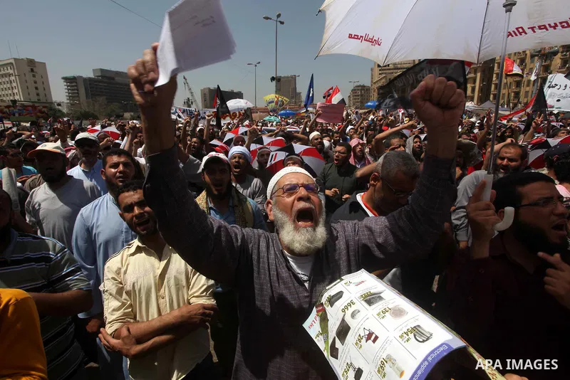 People attend Friday prayers in Tahrir Square in Cairo April 27, 2012. Tens of thousands of Egyptians demanded on Friday that their military rulers stick to a pledge to hand over power by mid-year after a row over who ca...