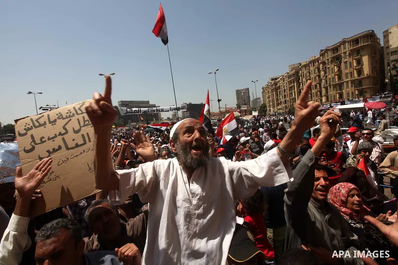 People attend Friday prayers in Tahrir Square in Cairo April 27, 2012. Tens of thousands of Egyptians demanded on Friday that their military rulers stick to a pledge to hand over power by mid-year after a row over who ca...