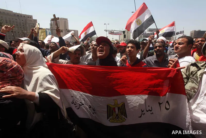 People attend Friday prayers in Tahrir Square in Cairo April 27, 2012. Tens of thousands of Egyptians demanded on Friday that their military rulers stick to a pledge to hand over power by mid-year after a row over who ca...