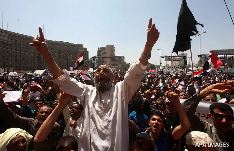 People attend Friday prayers in Tahrir Square in Cairo April 27, 2012. Tens of thousands of Egyptians demanded on Friday that their military rulers stick to a pledge to hand over power by mid-year after a row over who ca...