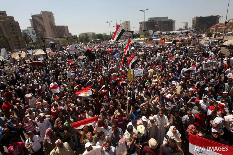 People attend Friday prayers in Tahrir Square in Cairo April 27, 2012. Tens of thousands of Egyptians demanded on Friday that their military rulers stick to a pledge to hand over power by mid-year after a row over who ca...