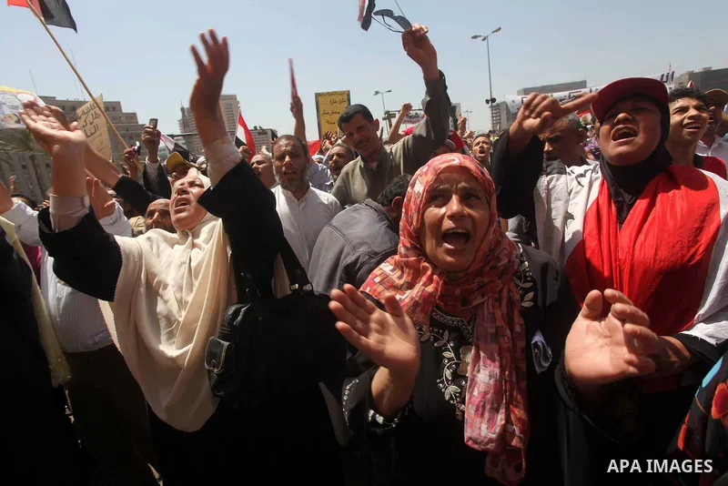 People attend Friday prayers in Tahrir Square in Cairo April 27, 2012. Tens of thousands of Egyptians demanded on Friday that their military rulers stick to a pledge to hand over power by mid-year after a row over who ca...