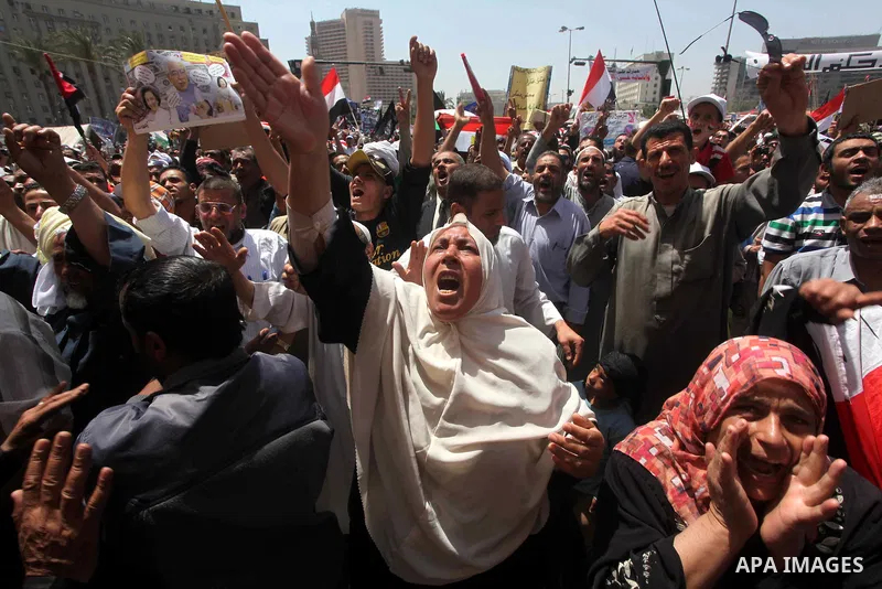 People attend Friday prayers in Tahrir Square in Cairo April 27, 2012. Tens of thousands of Egyptians demanded on Friday that their military rulers stick to a pledge to hand over power by mid-year after a row over who ca...