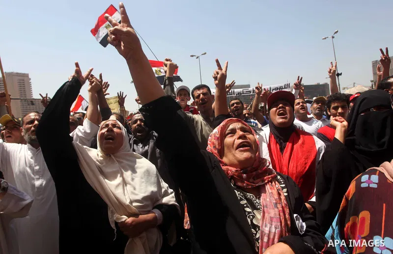 People attend Friday prayers in Tahrir Square in Cairo April 27, 2012. Tens of thousands of Egyptians demanded on Friday that their military rulers stick to a pledge to hand over power by mid-year after a row over who ca...