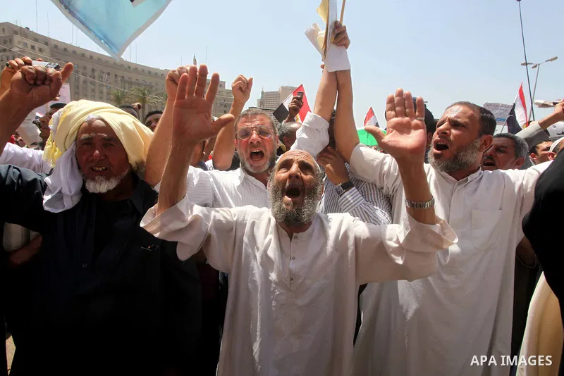 People attend Friday prayers in Tahrir Square in Cairo April 27, 2012. Tens of thousands of Egyptians demanded on Friday that their military rulers stick to a pledge to hand over power by mid-year after a row over who ca...