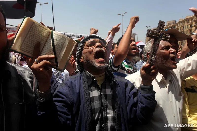 People attend Friday prayers in Tahrir Square in Cairo April 27, 2012. Tens of thousands of Egyptians demanded on Friday that their military rulers stick to a pledge to hand over power by mid-year after a row over who ca...