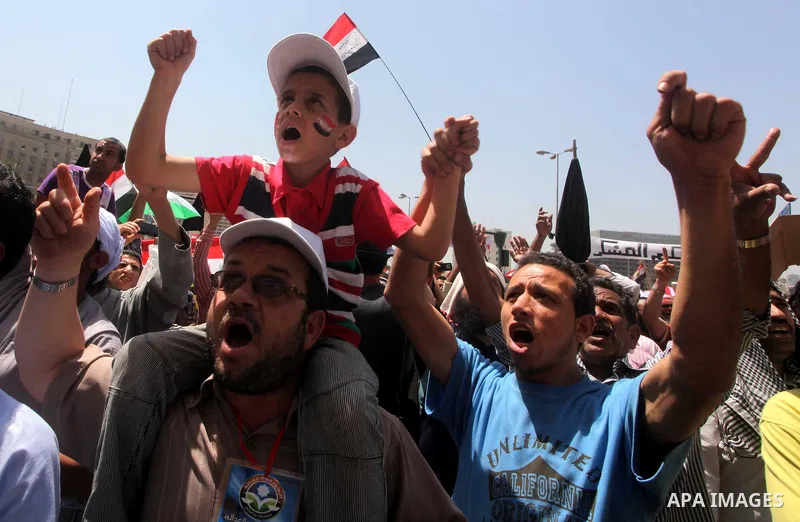 People attend Friday prayers in Tahrir Square in Cairo April 27, 2012. Tens of thousands of Egyptians demanded on Friday that their military rulers stick to a pledge to hand over power by mid-year after a row over who ca...