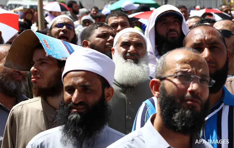 People attend Friday prayers in Tahrir Square in Cairo April 27, 2012. Tens of thousands of Egyptians demanded on Friday that their military rulers stick to a pledge to hand over power by mid-year after a row over who ca...