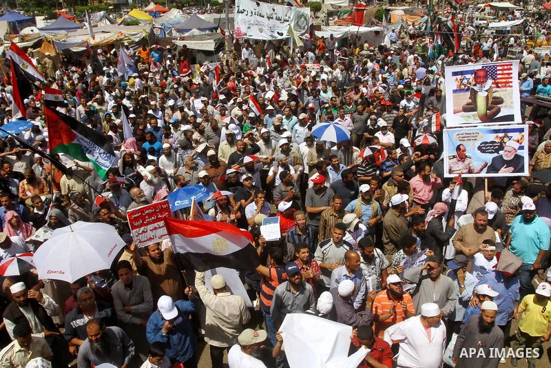 People attend Friday prayers in Tahrir Square in Cairo April 27, 2012. Tens of thousands of Egyptians demanded on Friday that their military rulers stick to a pledge to hand over power by mid-year after a row over who ca...