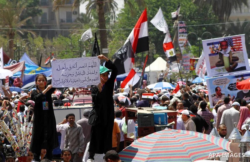 People attend Friday prayers in Tahrir Square in Cairo April 27, 2012. Tens of thousands of Egyptians demanded on Friday that their military rulers stick to a pledge to hand over power by mid-year after a row over who ca...