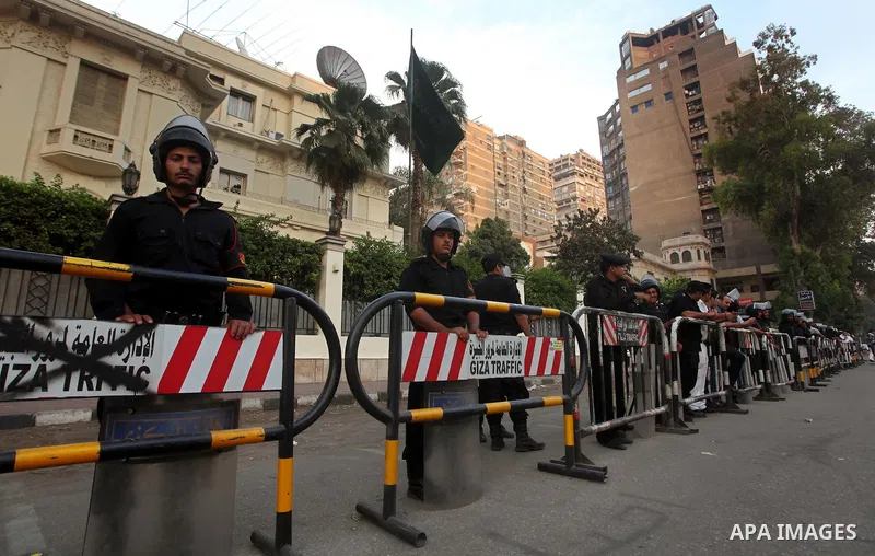 Egyptian security forces stand guard outside the Saudi Embassy in Cairo, Egypt during a demonstration to demand the release of an Egyptian human rights lawyer detained in Saudi Arabia for allegedly insulting the kingdom'...