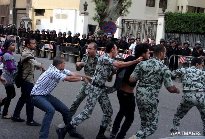 An Egyptian protester scuffles with security forces as they arrest a fellow demonstrator outside the Saudi embassy in Cairo on April 28, 2012. Saudi Arabia has decided to recall its ambassador to Cairo and close diplomat...