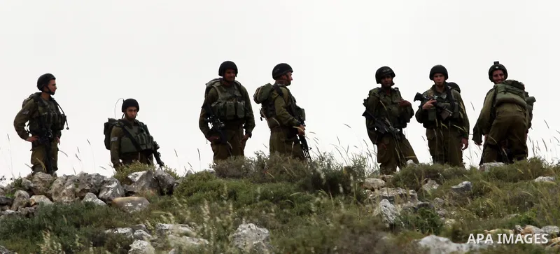 Israeli soldiers stand between Palestinian farmers and jewish settlers after clashes in Qusra village near the west bank city of Nablus, on April 29, 2012. Photo by Nedal Shtieh