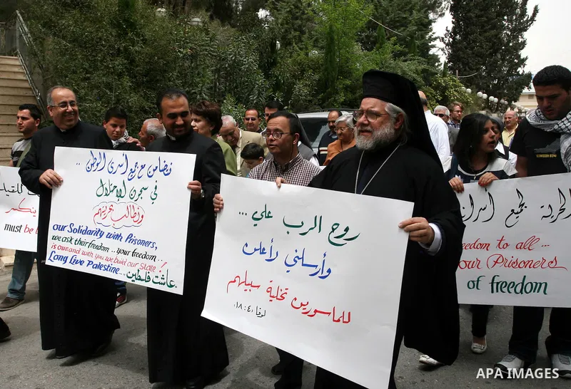Palestinian priests and Christians, protest in support of jailed Palestinians on hunger strike in Israeli prisons in the West Bank city of Ramallah on April 29, 2012. Over the past week, over 1,350 Palestinian prisoners...