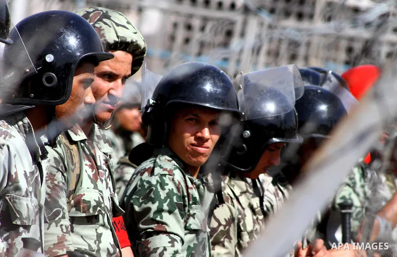 Egyptian soldiers standing guard outside the defence ministry in the Abbassiya district of Cairo on April 29, 2012 during a demonstartion against the interim military leadership. The first round of post-revolution presid...