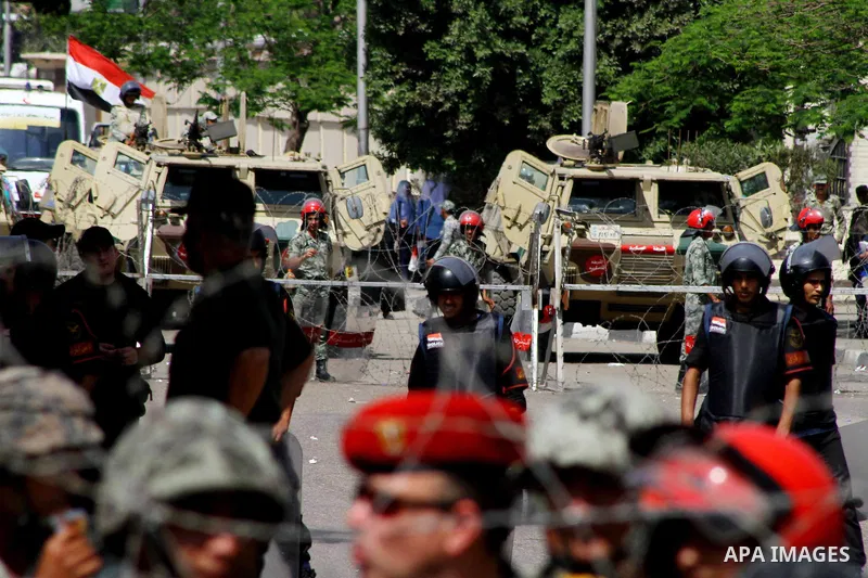 Egyptian protesters march back to the Ministry of Defense after battling thugs in the nearby streets of the Abasseya neighborhood of Cairo for several hours on Sunday, April 29, 2012. The army had mover back their securi...