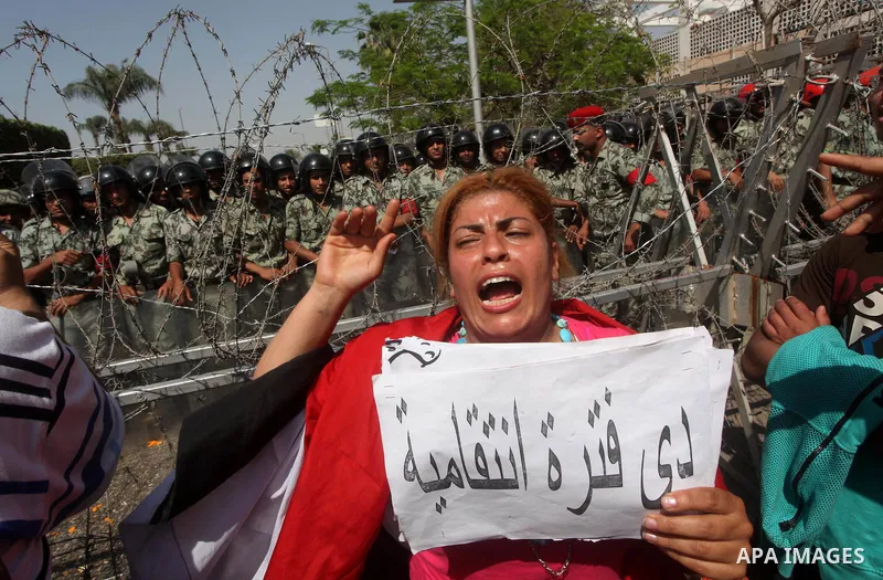 Egyptian protesters march back to the Ministry of Defense after battling thugs in the nearby streets of the Abasseya neighborhood of Cairo for several hours on Sunday, April 29, 2012. The army had mover back their securi...