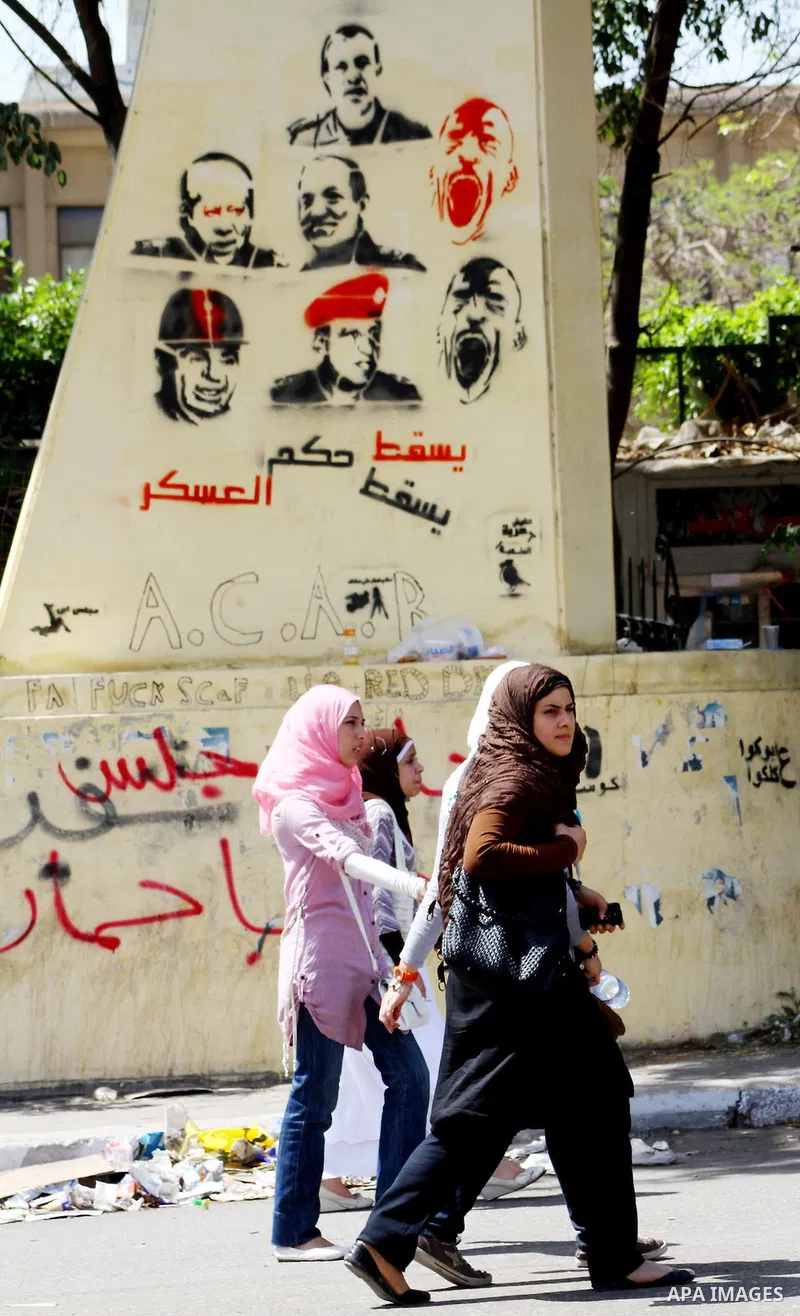 Egyptian protesters march back to the Ministry of Defense after battling thugs in the nearby streets of the Abasseya neighborhood of Cairo for several hours on Sunday, April 29, 2012. The army had mover back their securi...