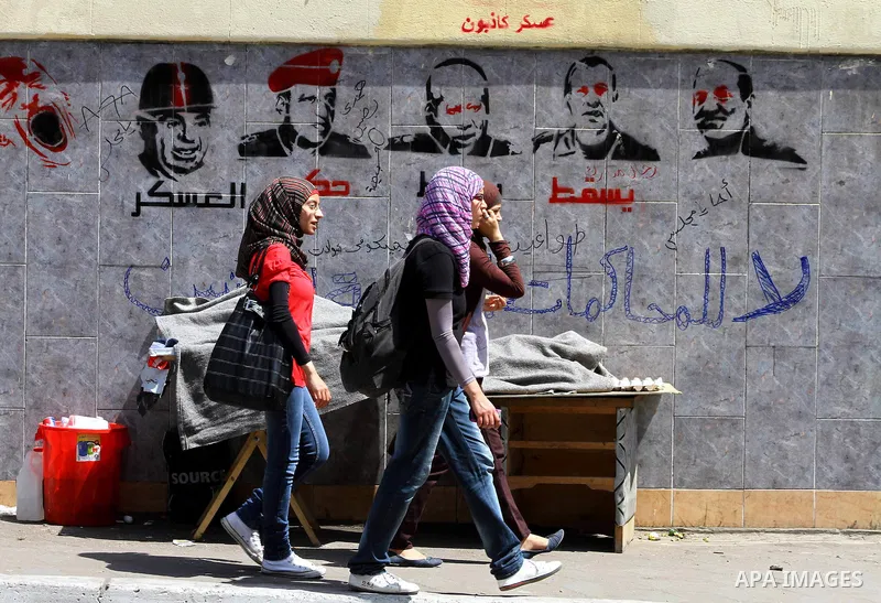Egyptian protesters march back to the Ministry of Defense after battling thugs in the nearby streets of the Abasseya neighborhood of Cairo for several hours on Sunday, April 29, 2012. The army had mover back their securi...