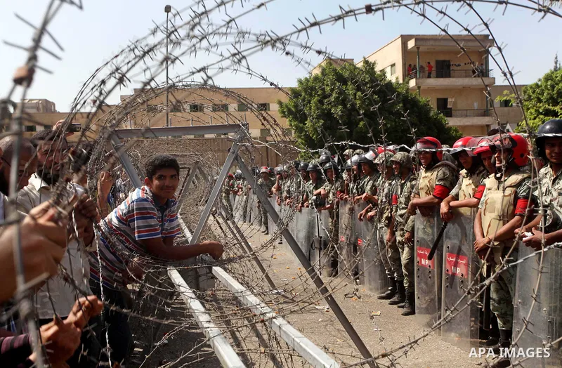 Egyptian protesters march back to the Ministry of Defense after battling thugs in the nearby streets of the Abasseya neighborhood of Cairo for several hours on Sunday, April 29, 2012. The army had mover back their securi...