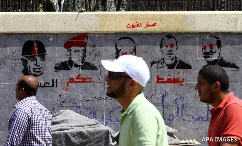 Egyptian protesters march back to the Ministry of Defense after battling thugs in the nearby streets of the Abasseya neighborhood of Cairo for several hours on Sunday, April 29, 2012. The army had mover back their securi...