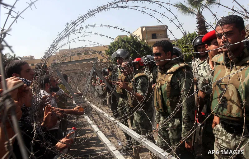 Egyptian protesters march back to the Ministry of Defense after battling thugs in the nearby streets of the Abasseya neighborhood of Cairo for several hours on Sunday, April 29, 2012. The army had mover back their securi...