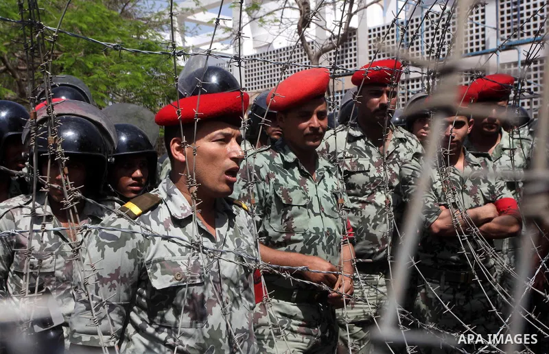 Egyptian protesters march back to the Ministry of Defense after battling thugs in the nearby streets of the Abasseya neighborhood of Cairo for several hours on Sunday, April 29, 2012. The army had mover back their securi...