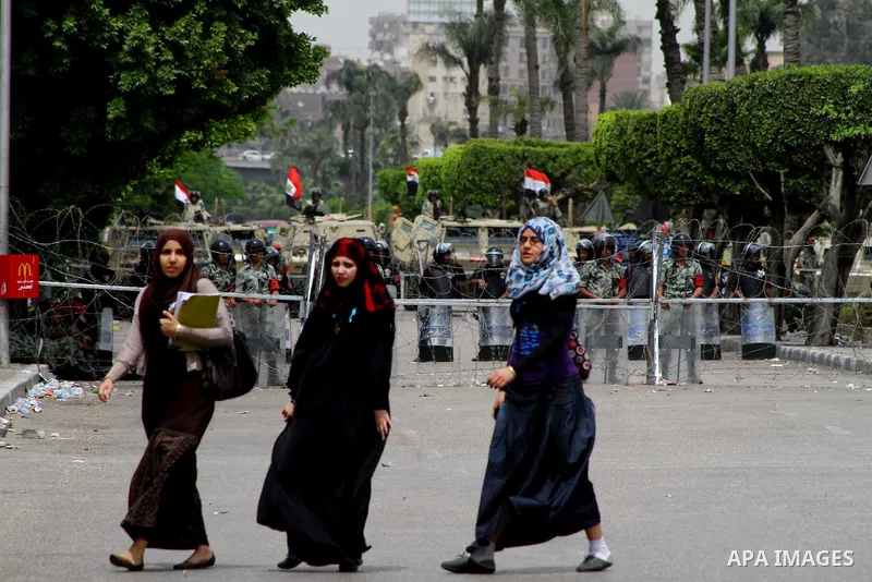 Egyptian students walk near the Ministry of Defense in the Abbassiya district of Cairo April 30, 2012. Protesters continued their sit-in on April 30 after they were attacked two days earlier, which resulted in the death...