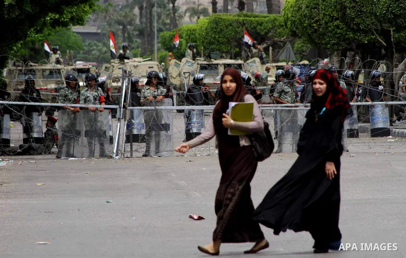 Egyptian students walk near the Ministry of Defense in the Abbassiya district of Cairo April 30, 2012. Protesters continued their sit-in on April 30 after they were attacked two days earlier, which resulted in the death...