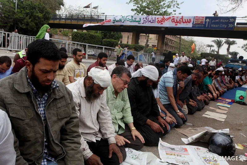 Egyptian Protesters pray near the Ministry of Defense in the Abbassiya district of Cairo April 30, 2012. Protesters continued their sit-in on April 30 after they were attacked two days earlier, which resulted in the deat...
