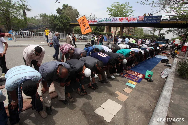Egyptian Protesters pray near the Ministry of Defense in the Abbassiya district of Cairo April 30, 2012. Protesters continued their sit-in on April 30 after they were attacked two days earlier, which resulted in the deat...