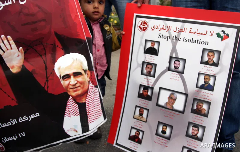 Palestinian protesters hold banners and portraits of a prisoners jailed in Israel,during a rally in solidarity with prisoners in Israeli jails, in the West Bank city of Ramallah, April 30, 2012. Over the past week, over...