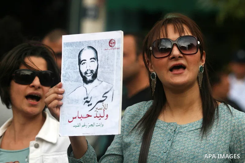 Palestinian protesters hold up banners and portraits of a prisoners jailed in Israel,during a rally in solidarity with prisoners in Israeli jails, in the West Bank city of Ramallah, April 30, 2012. Over the past week, ov...