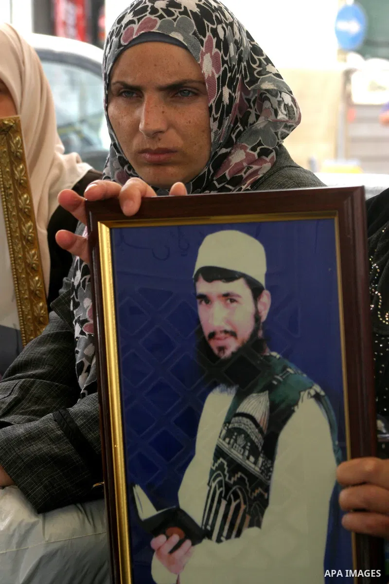 Palestinian woman holds up banners and portraits of a prisoners jailed in Israel, during a Sit-in held in the neighborhood of Sheikh Jarrah, in front of the Red Cross in the West Bank city of Jerusalem, April 30, 2012. O...