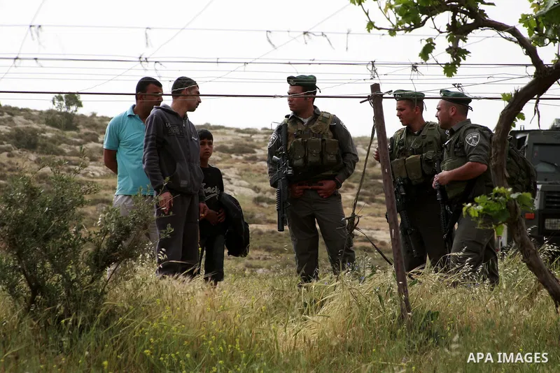 Israeli soldiers surround a bulldozer as it destroys a Palestinian farm to cows in the West Bank city of Hebron, May. 01, 2012. Reports state that tensions rose as Palestinian homes were destroyed by Israeli authorities...