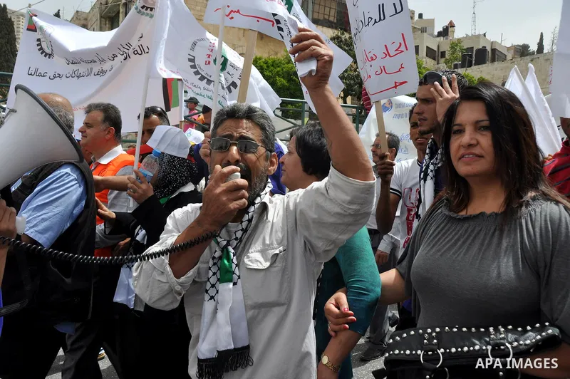 Palestinian workers shouting and calling Palestinian government to improve conditions of workers and create jobs during a protest in the West Bank city of Nablus on May 01,2012. Photo by Nedal shtieh