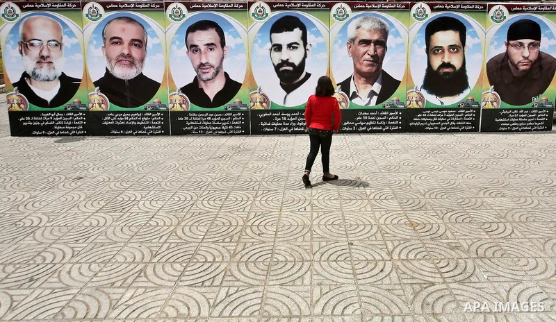 A Palestinian girl sees for prisoners photo during a rally to show solidarity with Palestinians prisoners held in Israeli jails, in Gaza City, May 01, 2012. Human rights groups say up to 2,000 prisoners have joined an op...